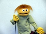 Yellow boy puppet with auburn hair.