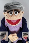 Ms. Moody is a woman puppet with salt and puppet hair and glasses.