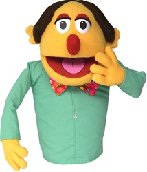 Mr. Quimper is a yellow cartoon puppet with red nose, bow tie and long sleeve shirt.