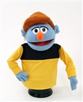 Herb is a blue boy puppet with auburn hair.
