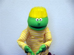 small green puppet with yellow flat top hair