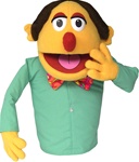 Mr. Quimper is a yellow cartoon puppet with red nose, bow tie and long sleeve shirt.