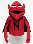 Red puppet with cape and evil eyes and pointy ears.  Puppet is wearing a red and black cape.